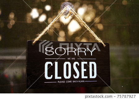 sorry we're closed . black and white wood sign on white wall 75787927
