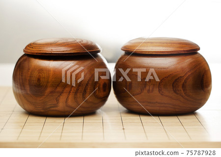Go game stones in wooden bowls - Goban, Baduk, Weiqi or Maklom - Traditional asian strategy board game 75787928