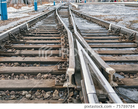 Frog (common crossing) of rails on the Trans-Siberian Railroad. Close-up. Frog (common crossing) of rails on the Trans-Siberian Railroad. Close-up. 75789784
