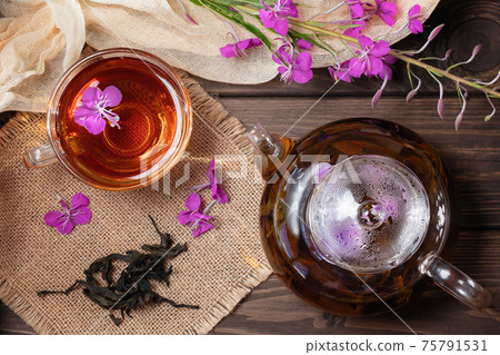 Herbal tea made from fireweed known as blooming sally in teapot and cup, top view 75791531