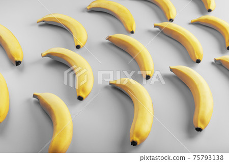 Geometric pattern of yellow bananas on a gray background in the Fashionable colors of 2021. 75793138