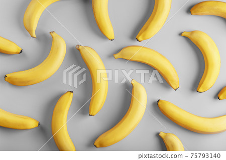 Bright pattern of yellow bananas on a gray background fashionable colors of 2021 75793140