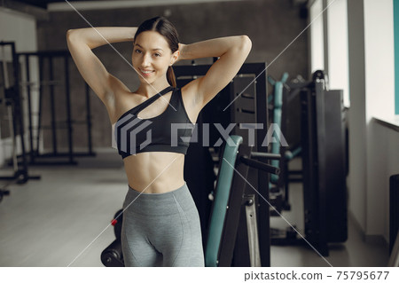 A beautiful girl is engaged in a gym 75795677