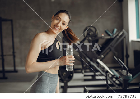 A beautiful girl is engaged in a gym 75795735