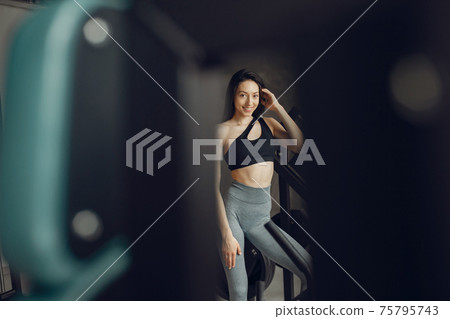 A beautiful girl is engaged in a gym 75795743