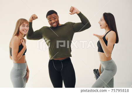 Sports group standing on a white background Sports group standing on a white background 75795818