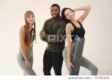 Sports group standing on a white background Sports group standing on a white background 75795819