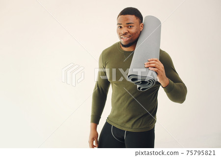 Handsome black man doing yoga on a white background Handsome black man doing yoga on a white background 75795821