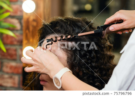 Hair styling process. Afro curls. Beauty industry. 75796796