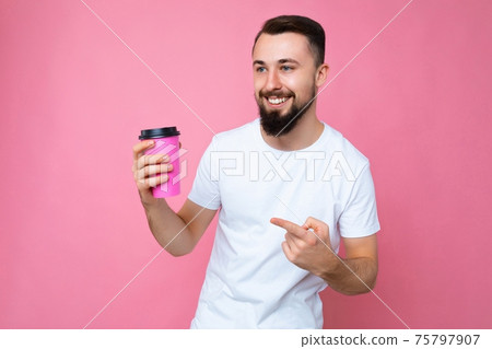 photo of handsome happy young brunette unshaven man with beard wearing white t-shirt isolated over photo of handsome happy young brunette unshaven man with beard wearing white t-shirt isolated over 75797907