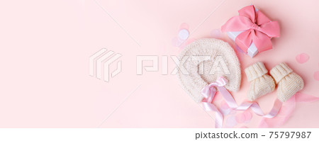 Beautiful composition with baby booties shoes, bonnet and gift box on pink background. Concept of baby shower party, pregnancy, mother day, first birthday holiday card, copy space, banner 75797987