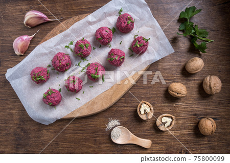 Georgian beetroot phali or pkhali with walnuts, garlic and spices on wooden background. 75800099