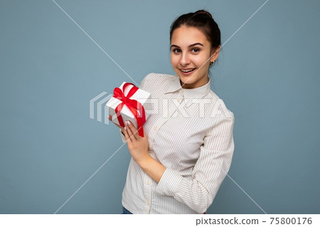 Beautiful happy young brunette woman isolated over colourful background wall wearing stylish casual 75800176