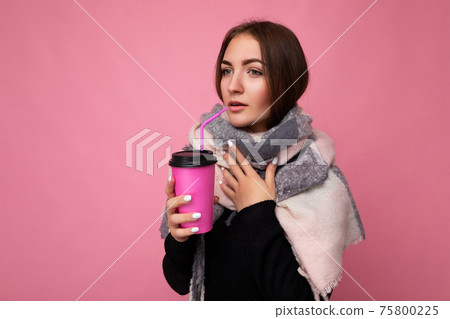 Photo shot of beautiful upset young brunette woman wearing black sweater and warm scarf isolated Photo shot of beautiful upset young brunette woman wearing black sweater and warm scarf isolated 75800225
