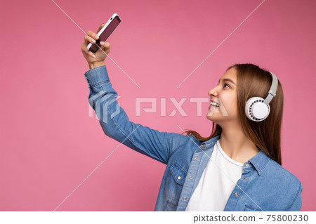 Side-profile Photo of attractive positive smiling young dark blonde woman wearing blue jean stylish Side-profile Photo of attractive positive smiling young dark blonde woman wearing blue jean stylish 75800230