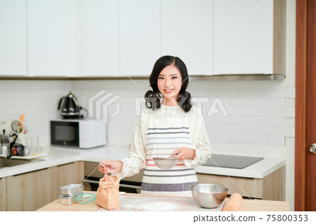 cooking and home concept - close up of female hands kneading dough at home 75800353