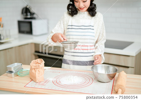 Making dough by female hands at bakery Making dough by female hands at bakery 75800354