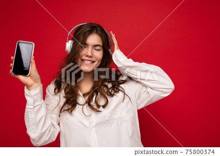 Attractive positive smiling young woman wearing stylish casual outfit isolated on colourful Attractive positive smiling young woman wearing stylish casual outfit isolated on colourful 75800374