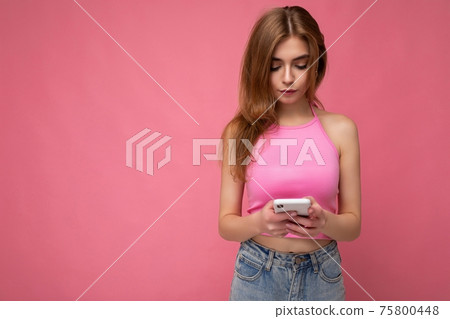 Photo shot of concentrated attractive positive good looking young woman wearing casual stylish Photo shot of concentrated attractive positive good looking young woman wearing casual stylish 75800448