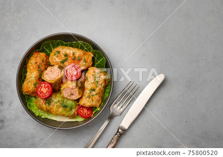 Golubtsi or golabki in bowl on concrete table top. Stuffed cabbage rolls of russian, polish cuisine Golubtsi or golabki in bowl on concrete table top. Stuffed cabbage rolls of russian, polish cuisine 75800520