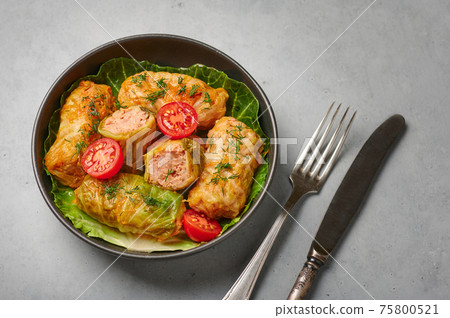 Golubtsi or golabki in bowl on concrete table top. Stuffed cabbage rolls of russian, polish cuisine Golubtsi or golabki in bowl on concrete table top. Stuffed cabbage rolls of russian, polish cuisine 75800521