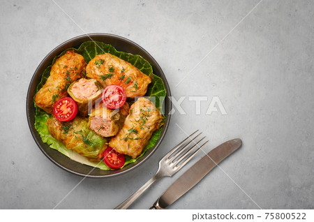 Golubtsi or golabki in bowl on concrete table top. Stuffed cabbage rolls of russian, polish cuisine 75800522