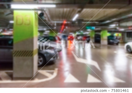 Garage car blurred. Car lot parking space in underground city garage. Empty road asphalt background in soft focus. Concrete skeleton for parking car. 75801461