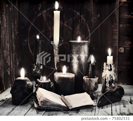 Grunge still life with burning candles and open diary book on witch table. Esoteric, gothic and occult background, Halloween mystic concept. Grunge still life with burning candles and open diary book on witch table. Esoteric, gothic and occult background, Halloween mystic concept. 75802531