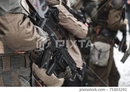Military with rifles in operation. Military with rifles in operation. 75803291