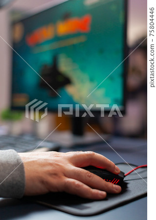 Close up hand of pro gamer in home studio using professional mouse Close up hand of pro gamer in home studio using professional mouse 75804446