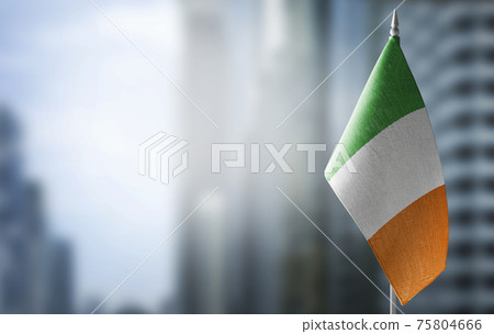 A small flag of Ireland on the background of a blurred background A small flag of Ireland on the background of a blurred background 75804666