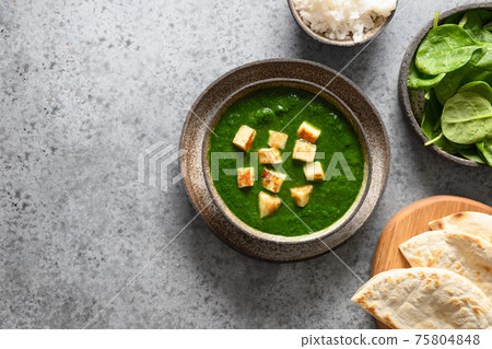 Palak Paneer served with basmati rice on grey. Indian vegetarian cuisine mades of spinach and paneer cheese. Palak Paneer served with basmati rice on grey. Indian vegetarian cuisine mades of spinach and paneer cheese. 75804848