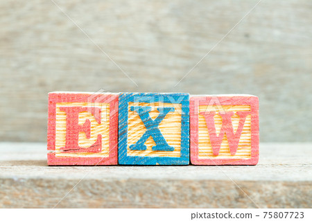 Color alphabet letter block in word EXW (abbreviation of Ex works) on wood background Color alphabet letter block in word EXW (abbreviation of Ex works) on wood background 75807723