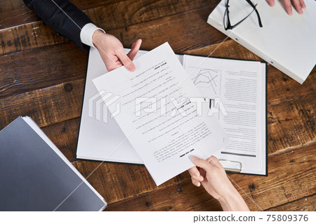 Asian business person handing over the contract 75809376