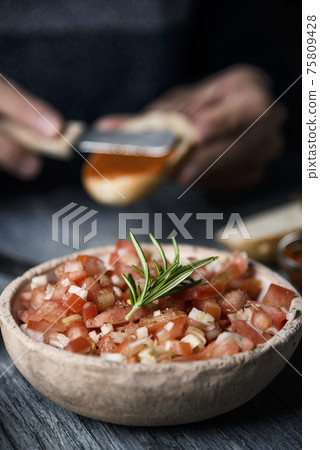 tomato salad and man preparing vegan appetizer tomato salad and man preparing vegan appetizer 75809428