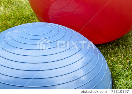 Balance training balls on green grass Balance training balls on green grass 75810597