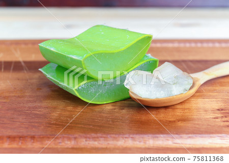 Green fresh Aloe vera sliced fresh aloe on wood table Green fresh Aloe vera sliced fresh aloe on wood table 75811368