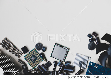 Top view of computer parts with CPU, fan cooler, battery, capacitors, chip, screwdrivers on white table background 75813372