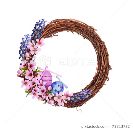 Dry brown rattan wreath with pink and blue spring flowers, Easter eggs and satin ribbon isolated on white Dry brown rattan wreath with pink and blue spring flowers, Easter eggs and satin ribbon isolated on white 75813782