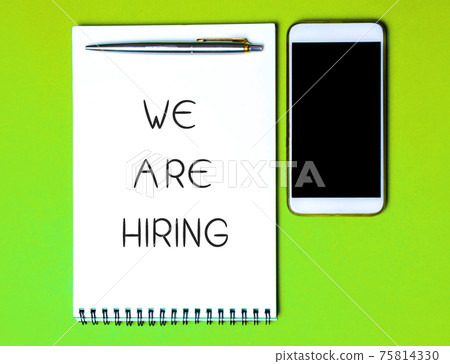 Notebook with the inscription We are hiring, a pen and a telephone. Employee Search. Attraction to work. Human Resource Management. Hire. Promotion. Working staff. Business concept 75814330