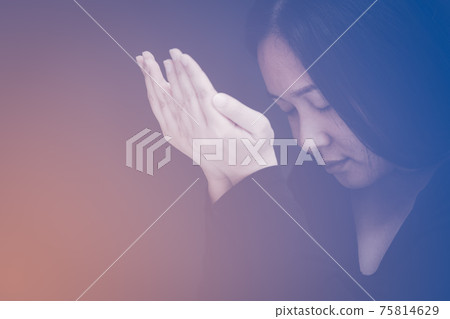 woman praying and worship to GOD Using hands to pray in religious beliefs and worship christian in the church or in general locations in vintage color tone or copy space. woman praying and worship to GOD Using hands to pray in religious beliefs and worship christian in the church or in general locations in vintage color tone or copy space. 75814629