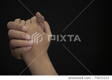 Woman's hand praying and worship to GOD Using hands to pray in religious beliefs and worship christian in the church or in general locations in black background or copy space. Woman's hand praying and worship to GOD Using hands to pray in religious beliefs and worship christian in the church or in general locations in black background or copy space. 75815222