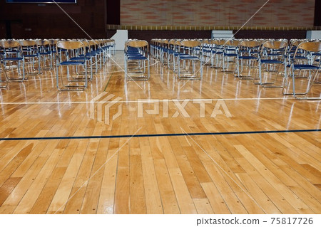 Pipe chairs lined up neatly in the gymnasium 75817726