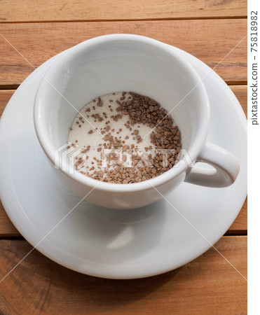 Instant coffee mix in a white porcelain cup Instant coffee mix in a white porcelain cup 75818982
