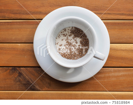 Instant coffee mix in a white porcelain cup Instant coffee mix in a white porcelain cup 75818984