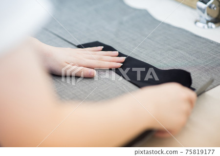 Craftsmen working in a garment factory 75819177