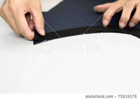 Craftsmen working in a garment factory 75819178