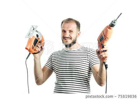 Portrait of handyman holding orange drill and electric jigsaw isolated on white Portrait of handyman holding orange drill and electric jigsaw isolated on white 75819836