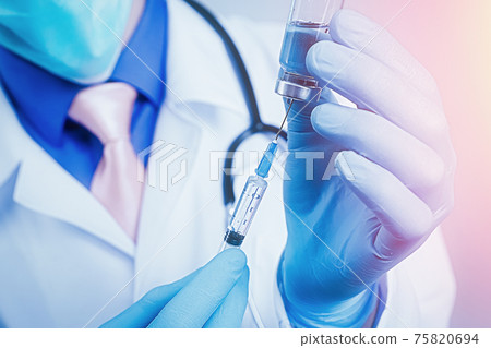 Close up view on syringe and glass ampoule in hands dressed in blue rubber gloves, white robe dressed doctor 75820694