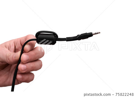 Close-up Jack plug and a cable. in the hands of a man on the white background.  75822248